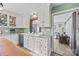 Modern kitchen with white cabinets and a farmhouse sink at 104 E Main St, Cleveland, NC 27013