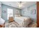 Charming bedroom with light walls, a comfortable bed, and a ceiling fan at 1117 Butterburr Dr, Matthews, NC 28104