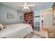 Bedroom with wooden shelving, ceiling fan, and access to hallway at 1117 Butterburr Dr, Matthews, NC 28104