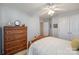 Comfortable bedroom with a dresser, ceiling fan, and double doors at 1117 Butterburr Dr, Matthews, NC 28104