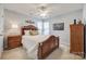 Light and airy bedroom with a wooden bed frame and ceiling fan at 1117 Butterburr Dr, Matthews, NC 28104