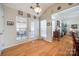 Kitchen nook with hardwood floors, a door to a screened porch, and lots of windows at 1117 Butterburr Dr, Matthews, NC 28104