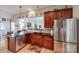 Modern kitchen with granite countertops, stainless steel appliances, and an island at 1117 Butterburr Dr, Matthews, NC 28104