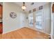 Bright kitchen nook with hardwood floors, access to a screened porch, and ample natural light at 1117 Butterburr Dr, Matthews, NC 28104