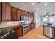 Kitchen with dark wood cabinets, granite countertops, and stainless steel appliances at 1117 Butterburr Dr, Matthews, NC 28104