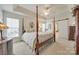 Spacious main bedroom with a four-poster bed and tray ceiling at 1117 Butterburr Dr, Matthews, NC 28104