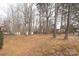 Large backyard with mature trees and sheds at 115 Tradewinds Ct, Mooresville, NC 28115