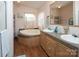 Bathroom with a corner bathtub and double vanity at 115 Tradewinds Ct, Mooresville, NC 28115