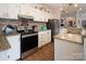 Modern kitchen with granite counters, stainless steel appliances, and white cabinetry at 115 Tradewinds Ct, Mooresville, NC 28115