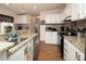 Bright kitchen with granite countertops, white cabinets, and a breakfast bar at 115 Tradewinds Ct, Mooresville, NC 28115