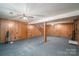 Finished basement with wood paneling and ceiling fan at 133 Devine St, Stanley, NC 28164