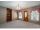 Dining room with built-in shelving and entryway at 133 Devine St, Stanley, NC 28164