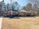 Brick ranch house with mature trees, a large yard, and a flag at 133 Devine St, Stanley, NC 28164