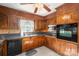 Kitchen with wood cabinets, granite counters, and black appliances at 133 Devine St, Stanley, NC 28164