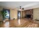 Living room with brick fireplace and hardwood floors at 133 Devine St, Stanley, NC 28164