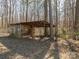 Rustic storage shed nestled in a wooded area at 133 Devine St, Stanley, NC 28164