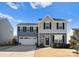 Two-story house with gray siding, white garage door, and landscaping at 139 Crownpiece St, Troutman, NC 28166