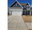 Two-story house with gray siding, white garage door, and stone accents at 1420 Nia Rd, Charlotte, NC 28215