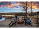 Fire pit with Adirondack chairs and stunning sunset lake views at 19107 Wildcat Trl, Davidson, NC 28036