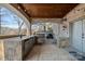 Outdoor kitchen with stone counters, stainless steel appliances, and a wood ceiling at 19107 Wildcat Trl, Davidson, NC 28036