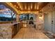 Outdoor kitchen with stone counters, stainless steel appliances, and a wood ceiling at 19107 Wildcat Trl, Davidson, NC 28036