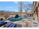 Luxury pool with spa and lake views; expansive patio with lounge chairs at 19107 Wildcat Trl, Davidson, NC 28036