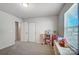 Bright bedroom featuring a playful toy setup and large window at 19117 Hawk Haven Ln, Charlotte, NC 28278