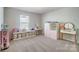 Well-lit bedroom with a vanity, storage, and toys at 19117 Hawk Haven Ln, Charlotte, NC 28278