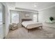 Primary bedroom with a queen bed and a relaxing armchair at 19117 Hawk Haven Ln, Charlotte, NC 28278