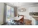 Bright dining area with patio access and a contemporary dining table at 19117 Hawk Haven Ln, Charlotte, NC 28278