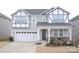 Two-story house with gray siding, white trim, and a welcoming front porch at 19117 Hawk Haven Ln, Charlotte, NC 28278