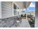 Front porch with stone detailing, seating, and a view of the neighborhood at 19117 Hawk Haven Ln, Charlotte, NC 28278