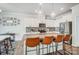 Bright kitchen with white cabinets, stainless steel appliances, bar stool seating, and granite countertops provides ample space at 19117 Hawk Haven Ln, Charlotte, NC 28278