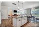 Kitchen island with granite countertop, seating, and stainless steel dishwasher at 19117 Hawk Haven Ln, Charlotte, NC 28278