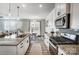 Modern kitchen with granite countertops, white cabinets, and stainless steel appliances at 19117 Hawk Haven Ln, Charlotte, NC 28278