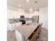 Bright kitchen features white cabinetry, stainless steel appliances, granite countertops, and a central island with barstool seating at 19117 Hawk Haven Ln, Charlotte, NC 28278