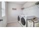 Laundry room with washer, dryer, and ample shelving at 19117 Hawk Haven Ln, Charlotte, NC 28278