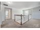 Upstairs hallway with carpeted floors and staircase to lower level at 19117 Hawk Haven Ln, Charlotte, NC 28278