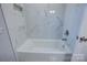 Clean bathroom with a bathtub and marble tile surround at 2025 Sloan Dr, Charlotte, NC 28208