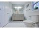 Elegant bathroom with double vanity and marble-look floors at 2025 Sloan Dr, Charlotte, NC 28208