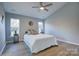 Spacious bedroom with a ceiling fan and natural light at 2025 Sloan Dr, Charlotte, NC 28208