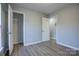 Well-lit bedroom with closet and access to another room at 2025 Sloan Dr, Charlotte, NC 28208