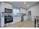 Modern kitchen with white cabinets and stainless steel appliances at 2025 Sloan Dr, Charlotte, NC 28208