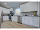 Modern kitchen with white cabinets, granite countertops, and stainless steel appliances at 2025 Sloan Dr, Charlotte, NC 28208