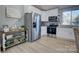 Modern kitchen with white cabinets and stainless steel appliances at 2025 Sloan Dr, Charlotte, NC 28208