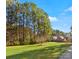 House nestled in a wooded area with a large grassy yard at 2044 Standing Timber Rd, Lancaster, SC 29720