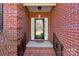 Brick front porch with a black door and iron railings at 2044 Standing Timber Rd, Lancaster, SC 29720