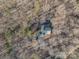 An aerial view of a quaint home nestled among trees with winter foliage at 209 Meadowridge Dr, Maiden, NC 28650