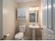 Small bathroom with pedestal sink and linen cabinet at 209 Meadowridge Dr, Maiden, NC 28650