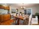 Virtually staged dining room with wood table and access to deck at 209 Meadowridge Dr, Maiden, NC 28650